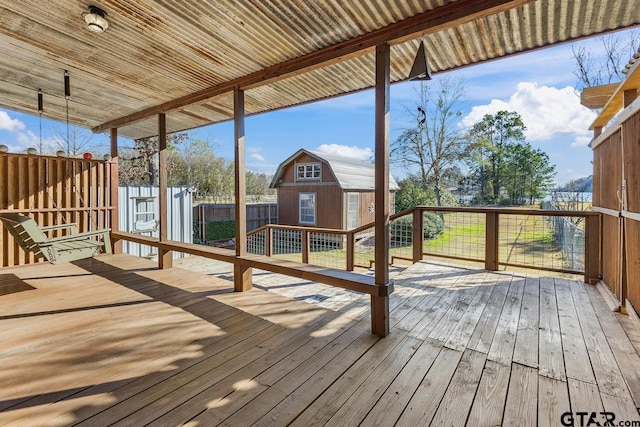 wooden deck with a storage shed