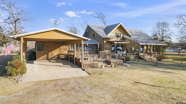 back of house featuring covered porch and a lawn