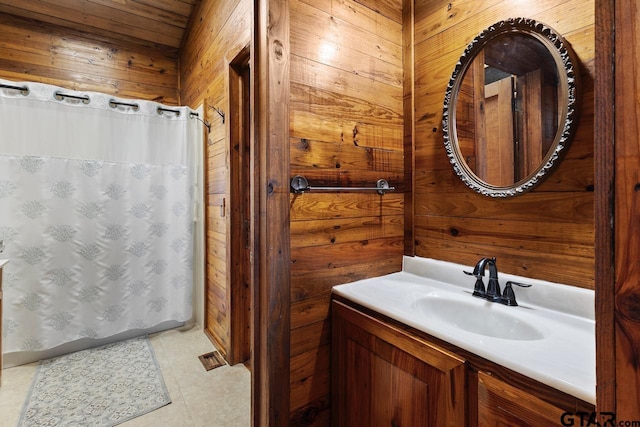 bathroom featuring vanity and wooden walls