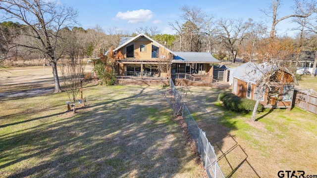 cabin with a front yard, a porch, and an outdoor structure