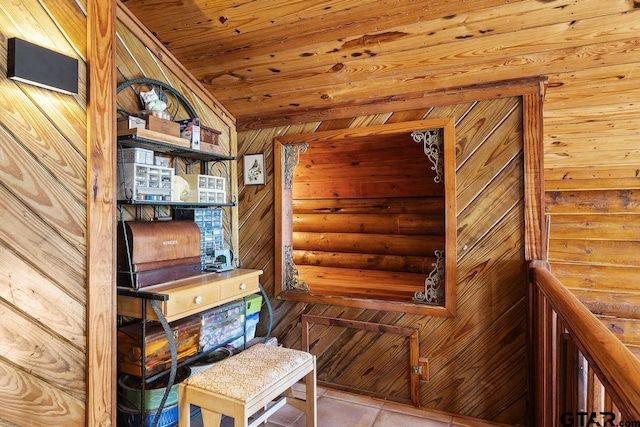 interior space with vaulted ceiling, wooden walls, light tile patterned floors, and wooden ceiling