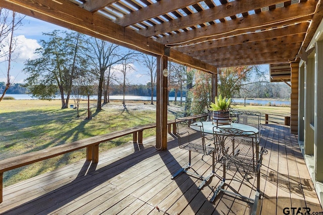 wooden terrace featuring a pergola, a water view, and a yard