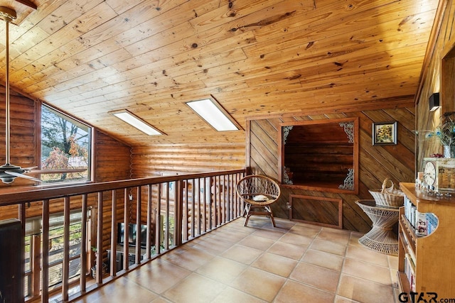 hall featuring wood ceiling, log walls, light tile patterned floors, and vaulted ceiling with skylight