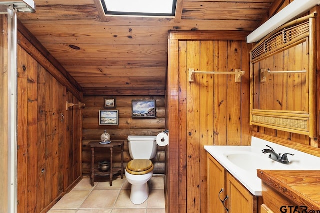 bathroom featuring vanity, wooden walls, toilet, rustic walls, and wooden ceiling