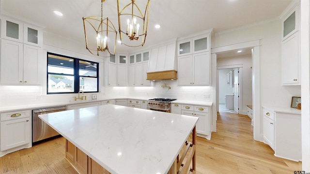 kitchen with a center island, white cabinets, and appliances with stainless steel finishes