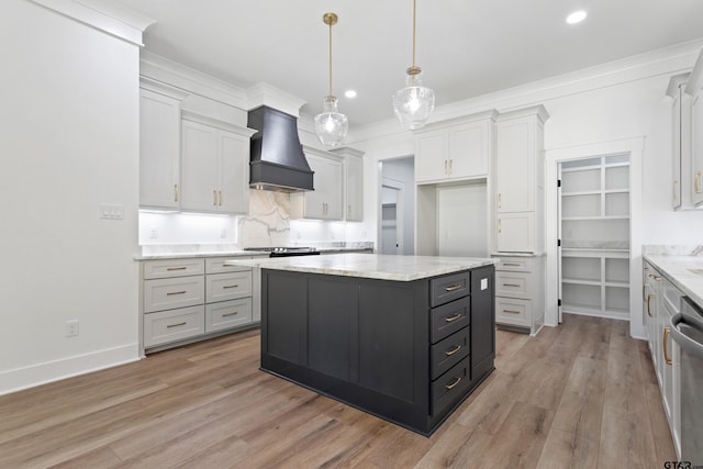 815 Redwing Way, Whitehouse, TX 75791 - kitchen featuring custom exhaust hood, tasteful backsplash, light wood-type flooring, a center island, and light stone countertops