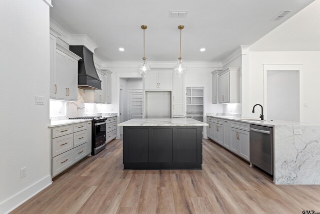815 Redwing Way, Whitehouse, TX 75791 - kitchen featuring appliances with stainless steel finishes, custom range hood, light stone counters, light wood-style floors, and recessed lighting