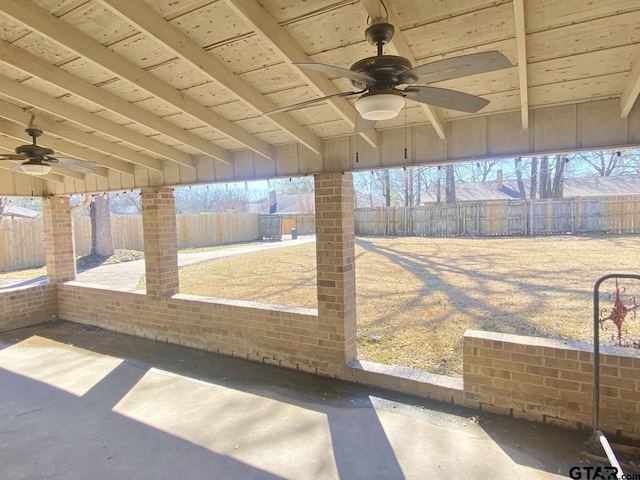 unfurnished sunroom featuring ceiling fan, beam ceiling, and wood ceiling