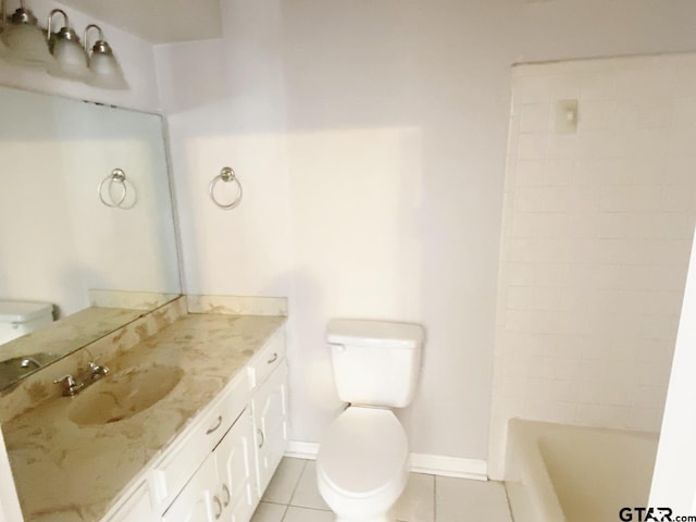 bathroom with tile patterned flooring, toilet, a washtub, vanity, and baseboards