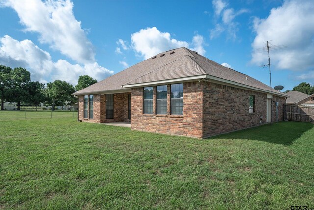 back of house with a yard