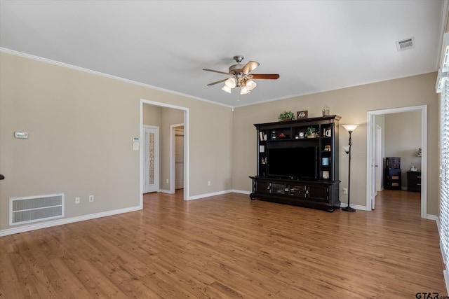 unfurnished living room featuring hardwood / wood-style flooring, crown molding, and ceiling fan