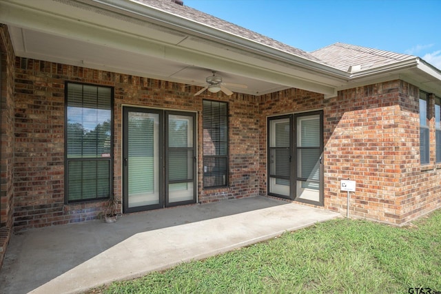 view of exterior entry featuring a patio and ceiling fan