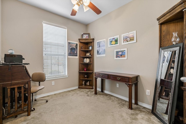 office space featuring ceiling fan, light colored carpet, and a healthy amount of sunlight