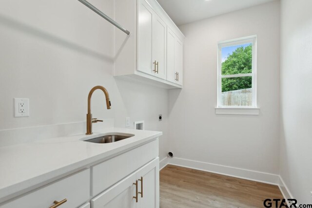 7201 Rolling Acres, Tyler, TX 75707 - washroom featuring cabinet space, hookup for an electric dryer, baseboards, washer hookup, and light wood-type flooring