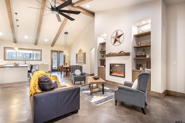 1490 Fm 13 E, Troup, TX 75789 - living room with concrete floors, built in shelves, ceiling fan, a glass covered fireplace, and arched walkways