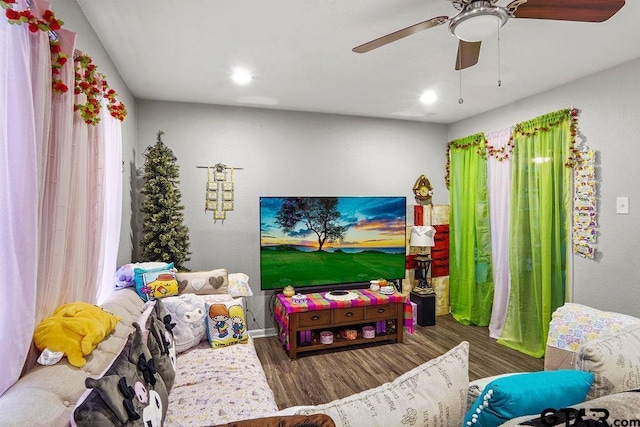 playroom featuring dark wood-type flooring and ceiling fan