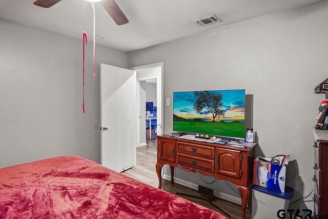 bedroom with ceiling fan and light hardwood / wood-style floors