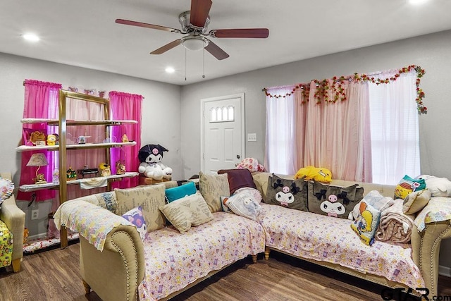 living room featuring dark hardwood / wood-style floors and ceiling fan