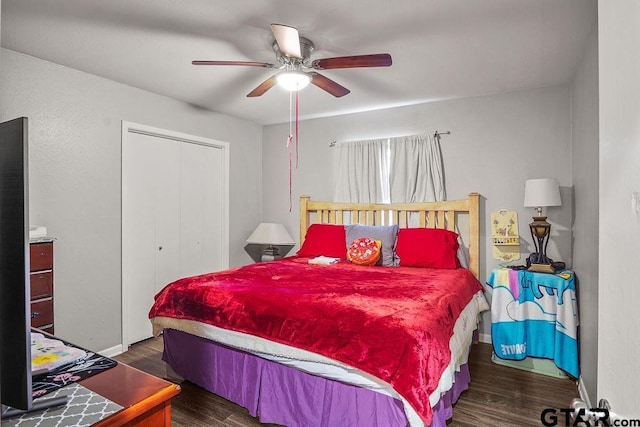 bedroom featuring dark wood-type flooring, ceiling fan, and a closet