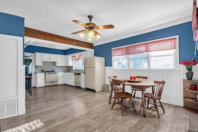 dining area featuring ceiling fan, beamed ceiling, and light hardwood / wood-style floors