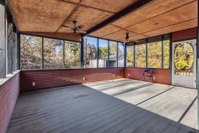 unfurnished sunroom featuring ceiling fan and wood ceiling