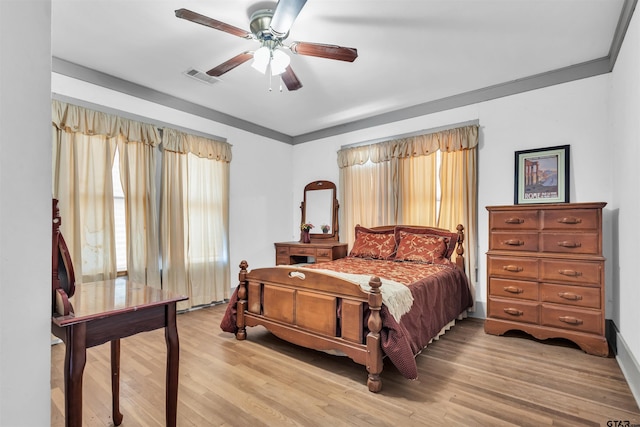 bedroom featuring ceiling fan, light hardwood / wood-style flooring, and crown molding