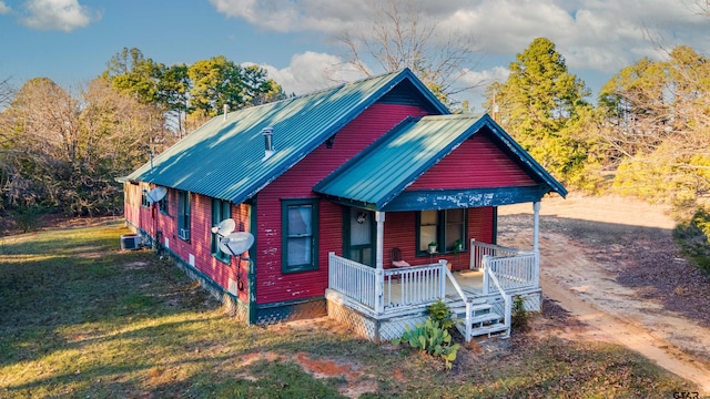 view of front of property with covered porch and a front yard