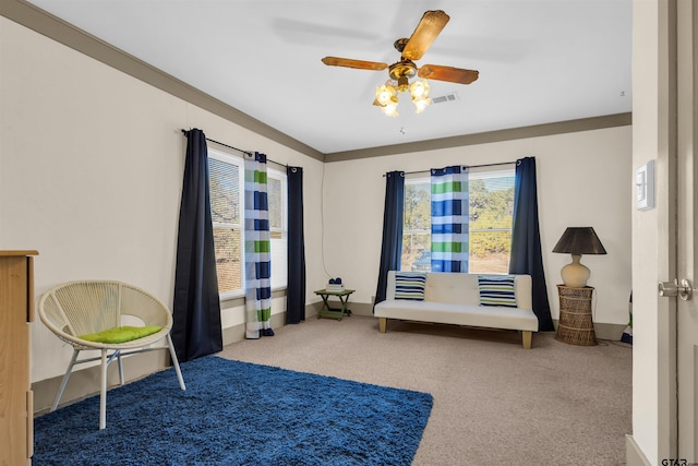 living area with ceiling fan and light colored carpet