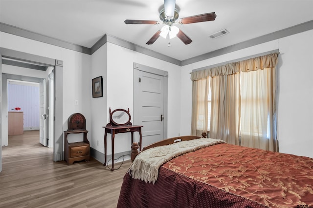 bedroom featuring light wood-type flooring and ceiling fan