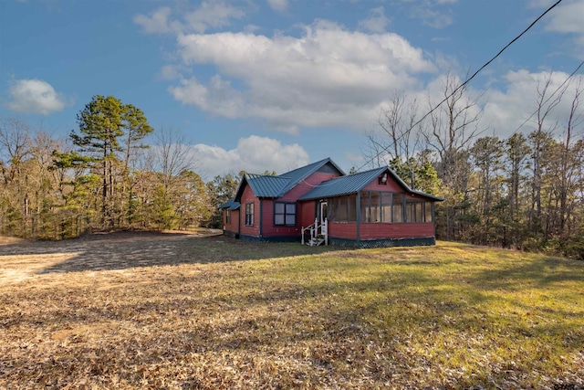 exterior space with a sunroom and a yard