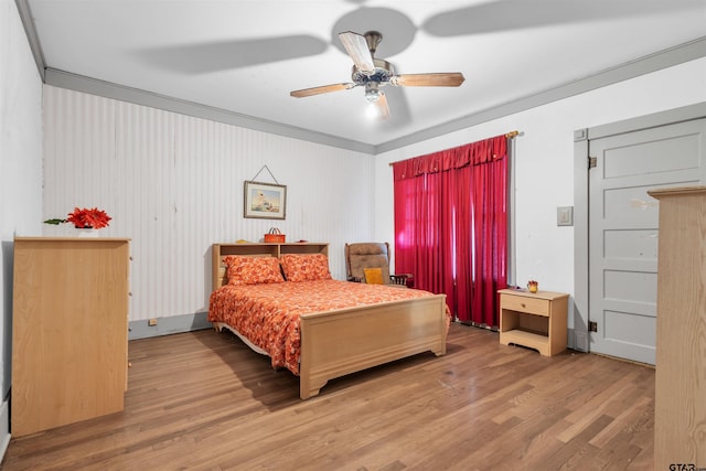 bedroom featuring ceiling fan, crown molding, and hardwood / wood-style flooring