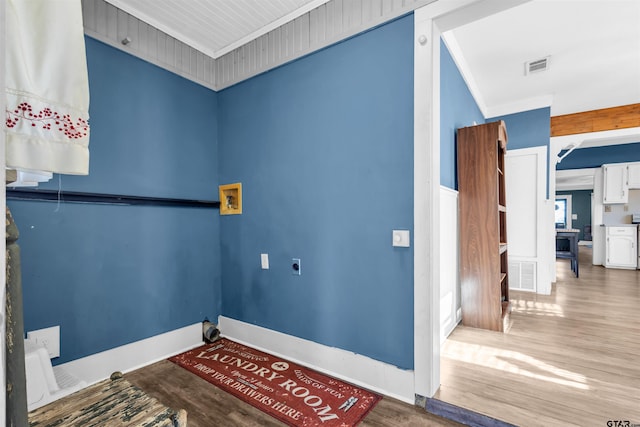 laundry room with crown molding, hardwood / wood-style floors, washer hookup, and hookup for an electric dryer