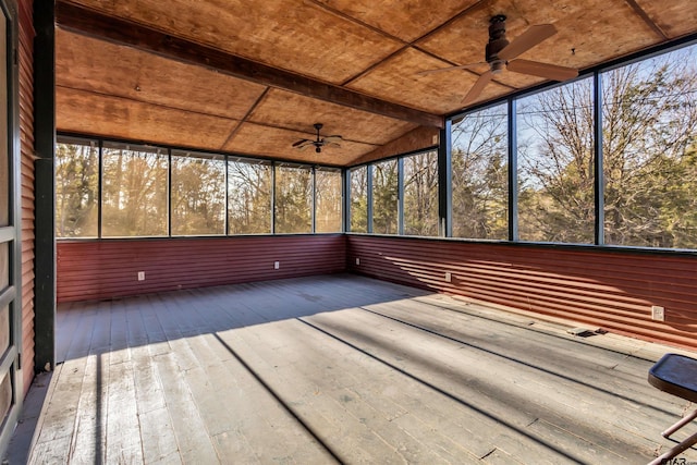 unfurnished sunroom featuring ceiling fan