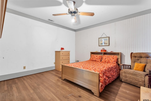 bedroom with hardwood / wood-style floors and ceiling fan