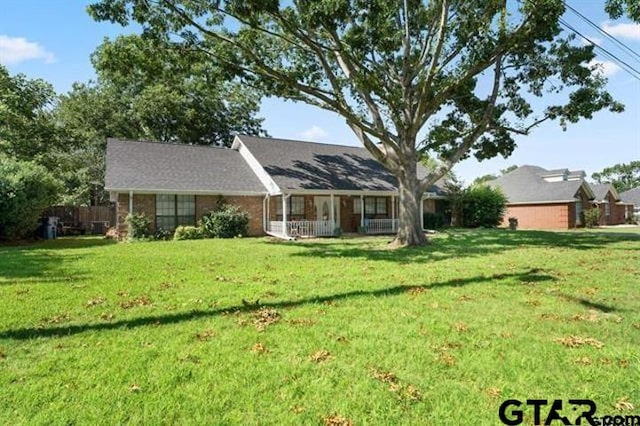 rear view of property with a lawn