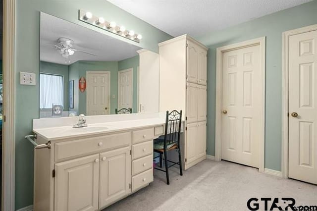 bathroom with ceiling fan and vanity