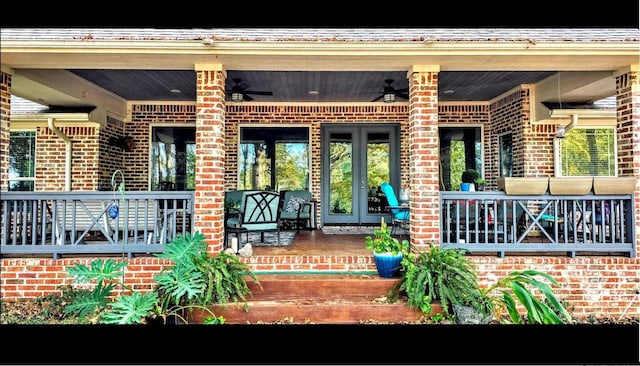 rear view of property featuring ceiling fan and covered porch