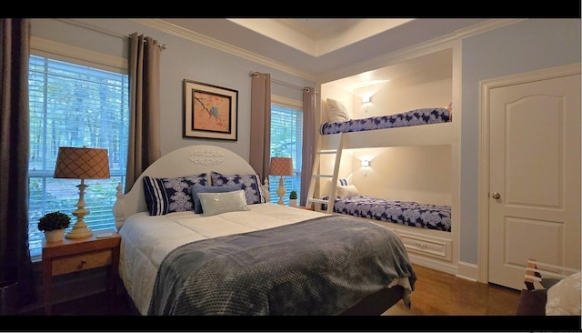 carpeted bedroom featuring multiple windows and ornamental molding