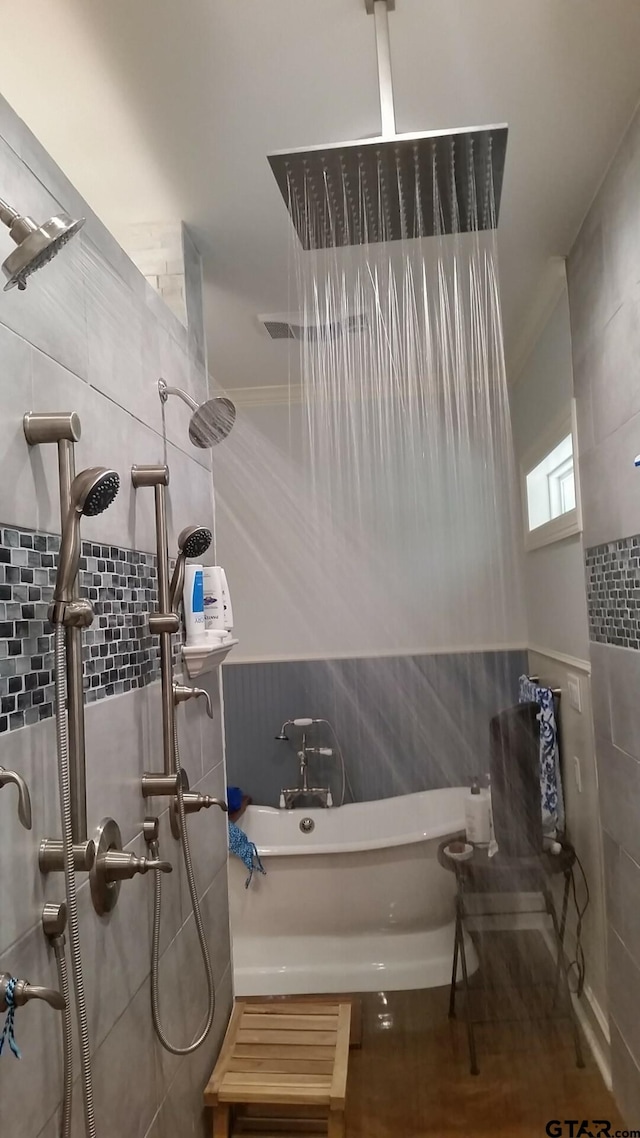 bathroom featuring tile walls and shower with separate bathtub