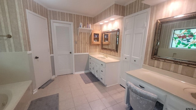 3802 Allendale Dr, Tyler, TX 75701 - bathroom with wallpapered walls, a closet, two vanities, tile patterned floors, and ornamental molding