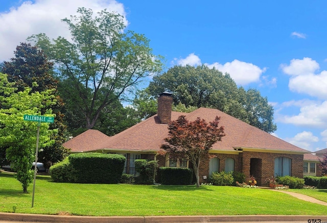 3802 Allendale Dr, Tyler, TX 75701 - view of front of home featuring a front lawn, a chimney, and brick siding