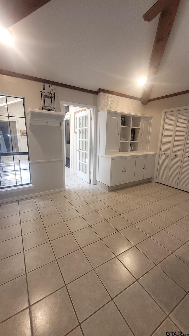 3802 Allendale Dr, Tyler, TX 75701 - empty room with light tile patterned floors, crown molding, and beamed ceiling