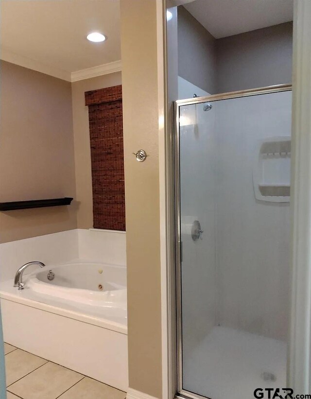 full bath featuring crown molding, a whirlpool tub, tile patterned floors, and a stall shower