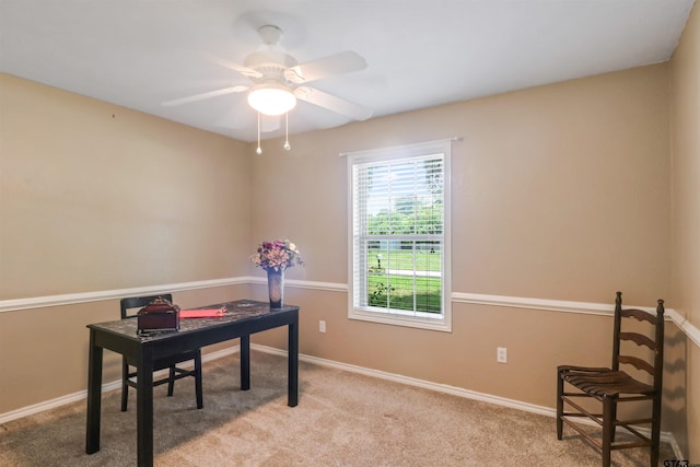 carpeted home office with ceiling fan