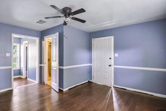 spare room featuring ceiling fan and dark hardwood / wood-style floors