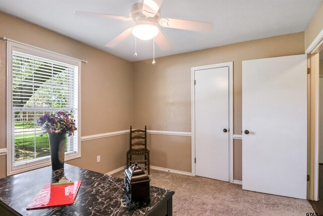 office space with ceiling fan and light colored carpet