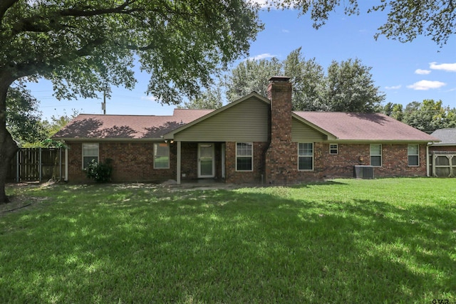 back of property featuring central AC and a yard