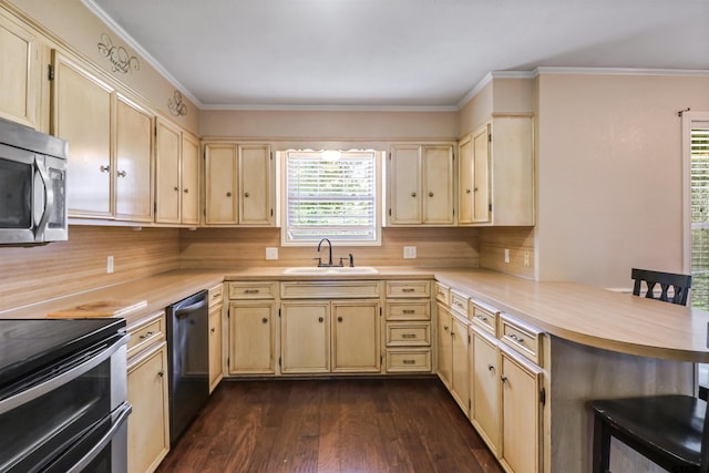 kitchen with dark wood-type flooring, kitchen peninsula, sink, crown molding, and appliances with stainless steel finishes