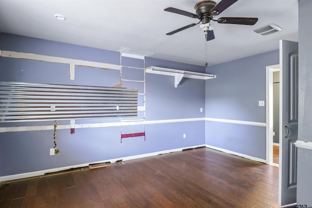 spare room featuring dark wood-type flooring and ceiling fan