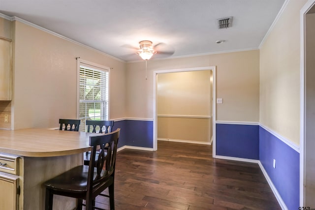 dining space featuring ornamental molding, dark hardwood / wood-style flooring, and ceiling fan